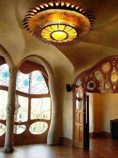 the inside of a house with stained glass windows and arched doorways on both sides