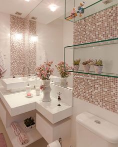 the bathroom is decorated in pink and white colors with flowers on the sink counter top