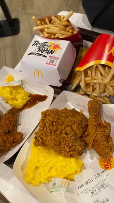 some chicken and fries are sitting on the table next to a mcdonald's box