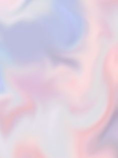 a blurry image of pink, blue and white swirls in the air on a soft background