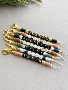 four pairs of scissors with letters on them sitting next to each other and the words new bead colors