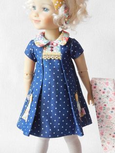 a doll with blonde hair wearing a blue dress
