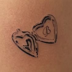 two heart shaped lockes on the back of a woman's stomach are drawn in black ink