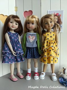 three dolls are standing next to each other