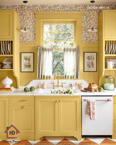 a kitchen with yellow cabinets and floral wallpaper on the walls, along with a white dishwasher