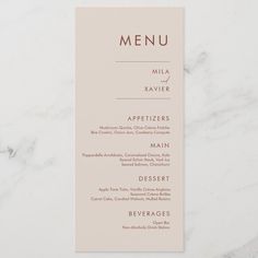 a menu card on a marble surface with the word menu written in gold foiling