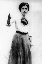 an old black and white photo of a woman with her hand up in the air