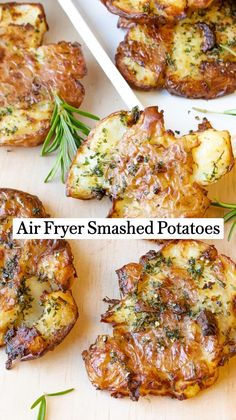 air fryer smashed potatoes on a cutting board with rosemary sprigs next to them