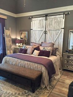 a bedroom with a bed, dressers and mirror in it's center area