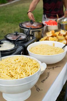 bowls of pasta and other foods on a table