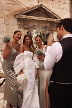 the bride and her friends are taking pictures