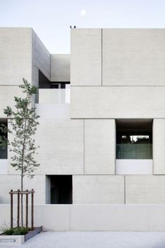 the building is made of concrete and has two windows on each side that are open to let in light