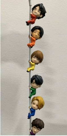 the beatles figurines are lined up on a pole