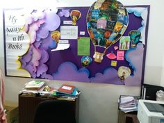 there is a bulletin board with many pictures on it and a hot air balloon in the middle