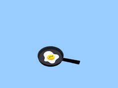 an egg frying in a pan on a blue background