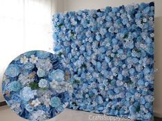 a large blue flowered wall hanging on the side of a white wall next to a window