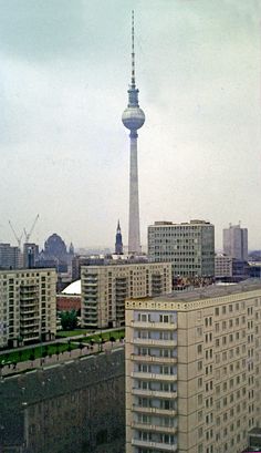 a city with tall buildings and a television tower in the background