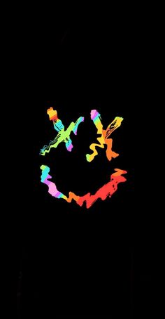 a colorful smiley face drawn in the dark