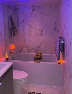 a bathroom with purple lighting on the walls, and a bathtub in the corner