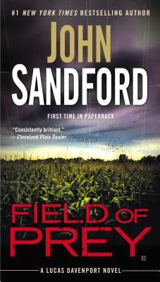 a book cover for field of prey by john sandford, first time in paperback