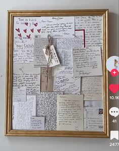 a collage of letters and hearts is hanging on the wall with a gold frame