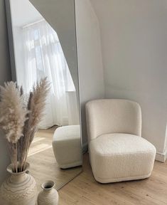 there is a chair and mirror in the room
