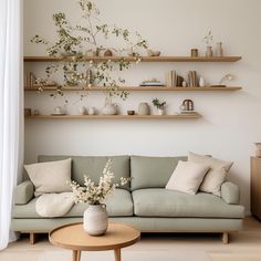 a living room filled with furniture and lots of shelfs on the wall above it