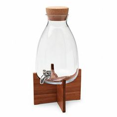 a wooden stand with a glass carafe on it