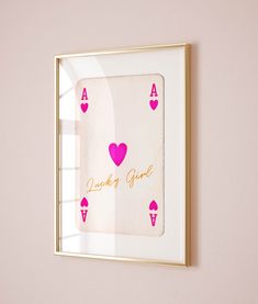 a pink and gold framed card game with hearts on it
