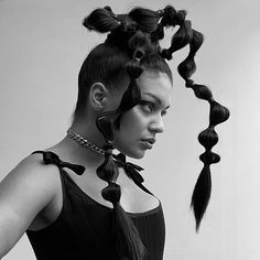 Sculptural braids represent a captivating and new way of doing dramatic hairdos. This trend transcends mere aesthetics, transforming braiding into a d... Braided Bun, Braided Space Buns
