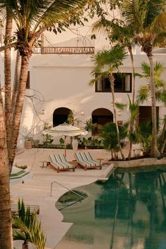 Striped loungers surround the pool. The Great Outdoors, Architecture, Outdoor, Maya, Resort, Hacienda, Hacienda Style, Hotel Swimming Pool