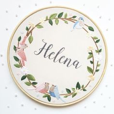 the embroidery pattern has birds and leaves on it, along with the word hello written in cursive writing