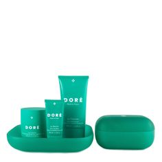 three green containers and one container with the word dore on it, sitting next to each other in front of a white background
