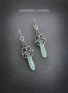 the earrings are made out of wire and glass