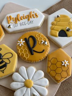 decorated cookies are arranged in the shape of honeycombs and beehives with words on them