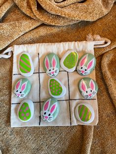six decorated easter eggs sitting on top of a cloth bag