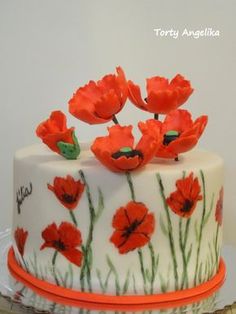 there is a cake decorated with red flowers