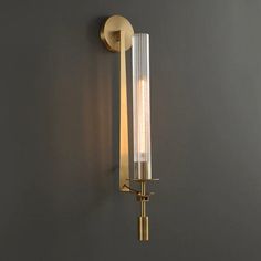 a wall light that is mounted on the side of a wall with two lights attached to it