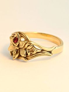 This detailed Orchid Ring is cast in solid 14K gold. A 2.5mm ruby is set in the center of the flower and the leaves of the orchid flow around the finger to form the band. It is 1/3 of an inch wide and rests flat against the finger. We will contact you to let you know if we have your chosen ring size in stock or when to expect shipment. All Marty Magic Jewelry is packaged in a beautiful ring box embossed with the gold foil Marty Magic dragon logo. Perfect for any occasion! Designed in Santa Cruz, Jewellery Rings, Gold Flower Ring, Ruby Ring, Orchid Ring, Gold Hand Ring, Ring Size, Jewelry Rings, Flower Ring, Flower Jewellery