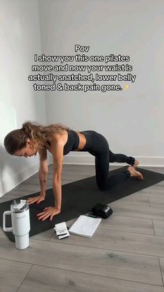 a woman is doing push ups on a yoga mat with a coffee mug in front of her