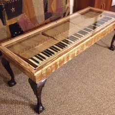 an old piano sitting on top of a carpeted floor