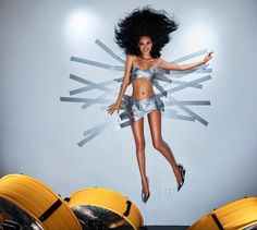a woman is jumping in the air with her hair flying