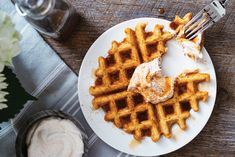 a plate with waffles and whipped cream on it