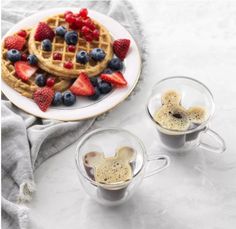 waffles with strawberries, blueberries and raspberries are served in mugs