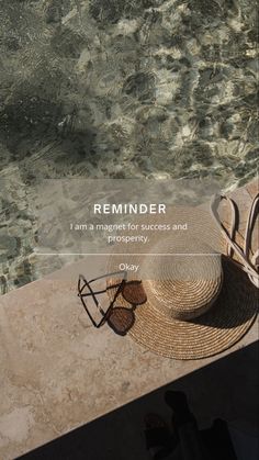 a straw hat and some chairs by the water with text reading reminder i am a target for success and prosperity