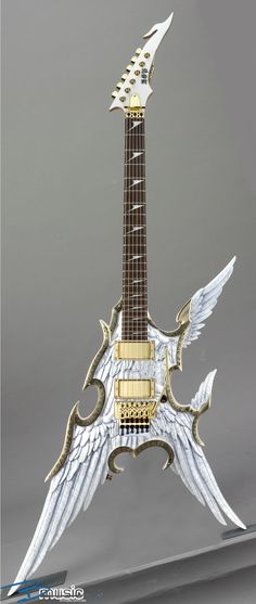 a guitar with wings on top of it