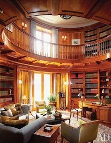 a living room filled with furniture and lots of books