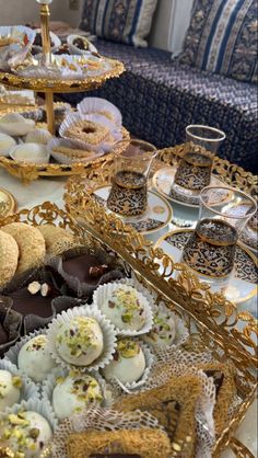 a table topped with lots of different types of pastries and desserts next to each other