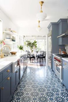 an image of a kitchen with blue cabinets and tile flooring on the walls, along with text that reads kitchen unusual dark blue gray grey kitchen cabinets