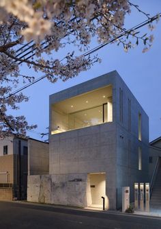 the building is made out of concrete and has an open floor plan with multiple levels